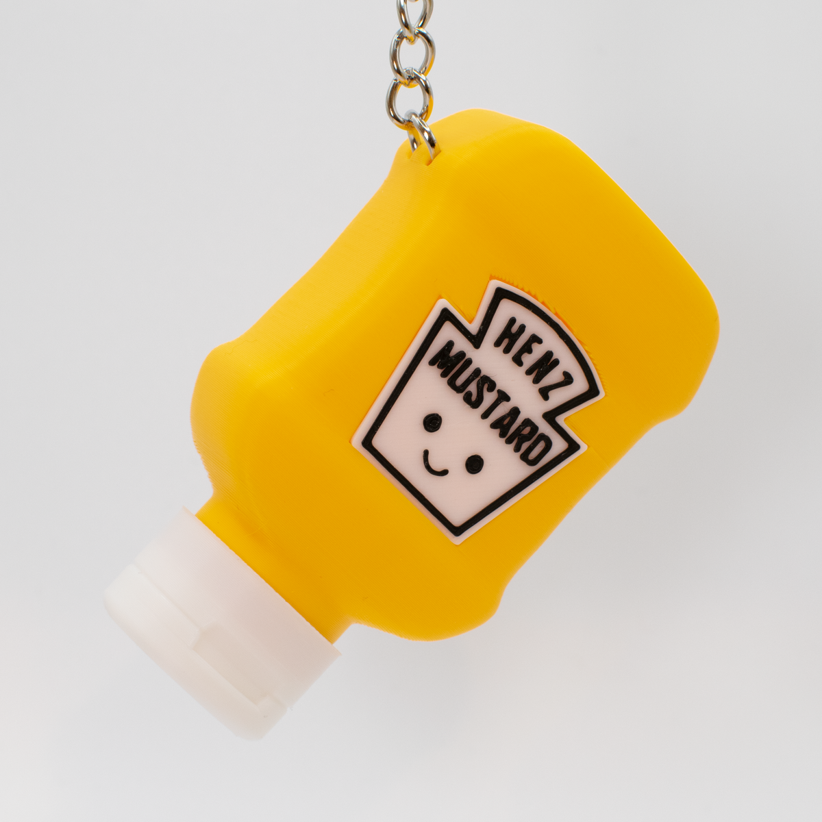 Mustard Bottle Fidget Clicker, as a bag charm
