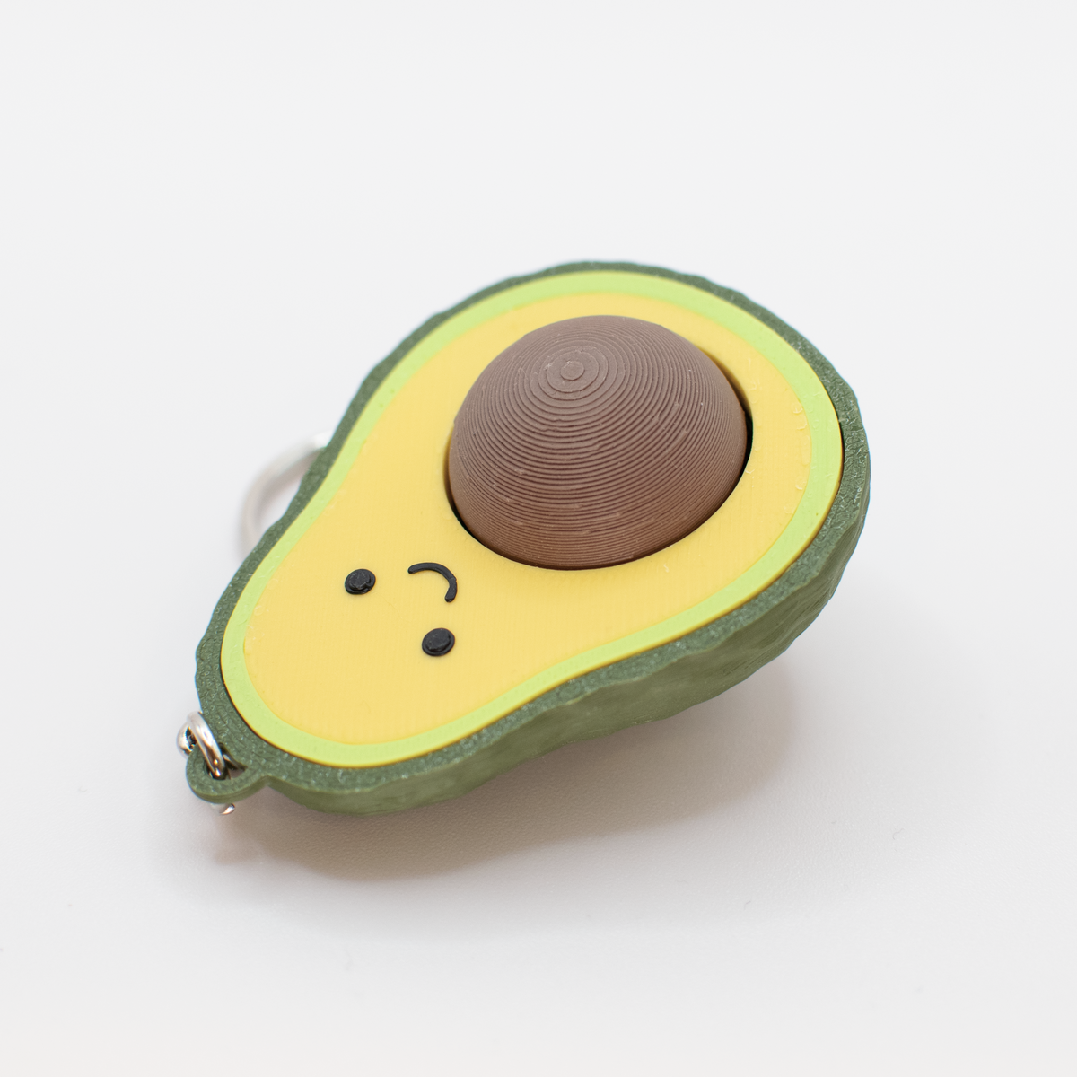 Avocado Fidget Clicker, on a desk