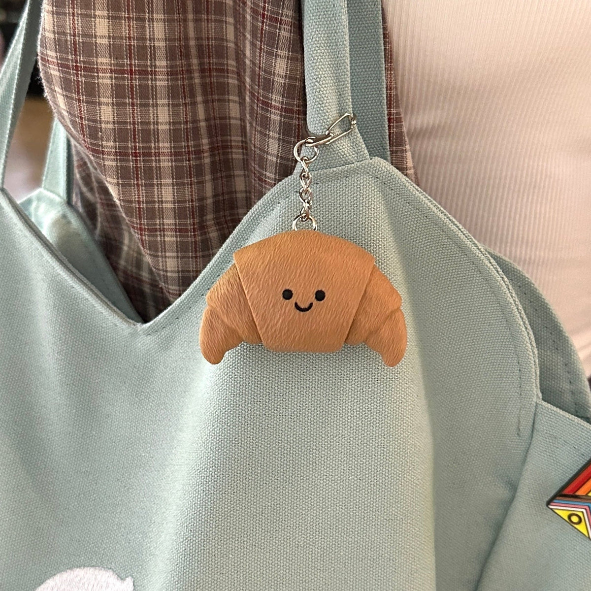 Croissant Fidget Clicker, as a bag charm