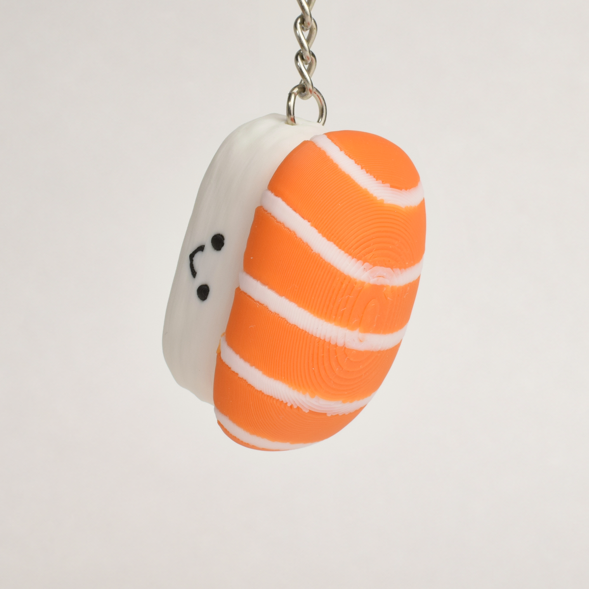 Salmon Sushi Fidget Clicker, on a keychain