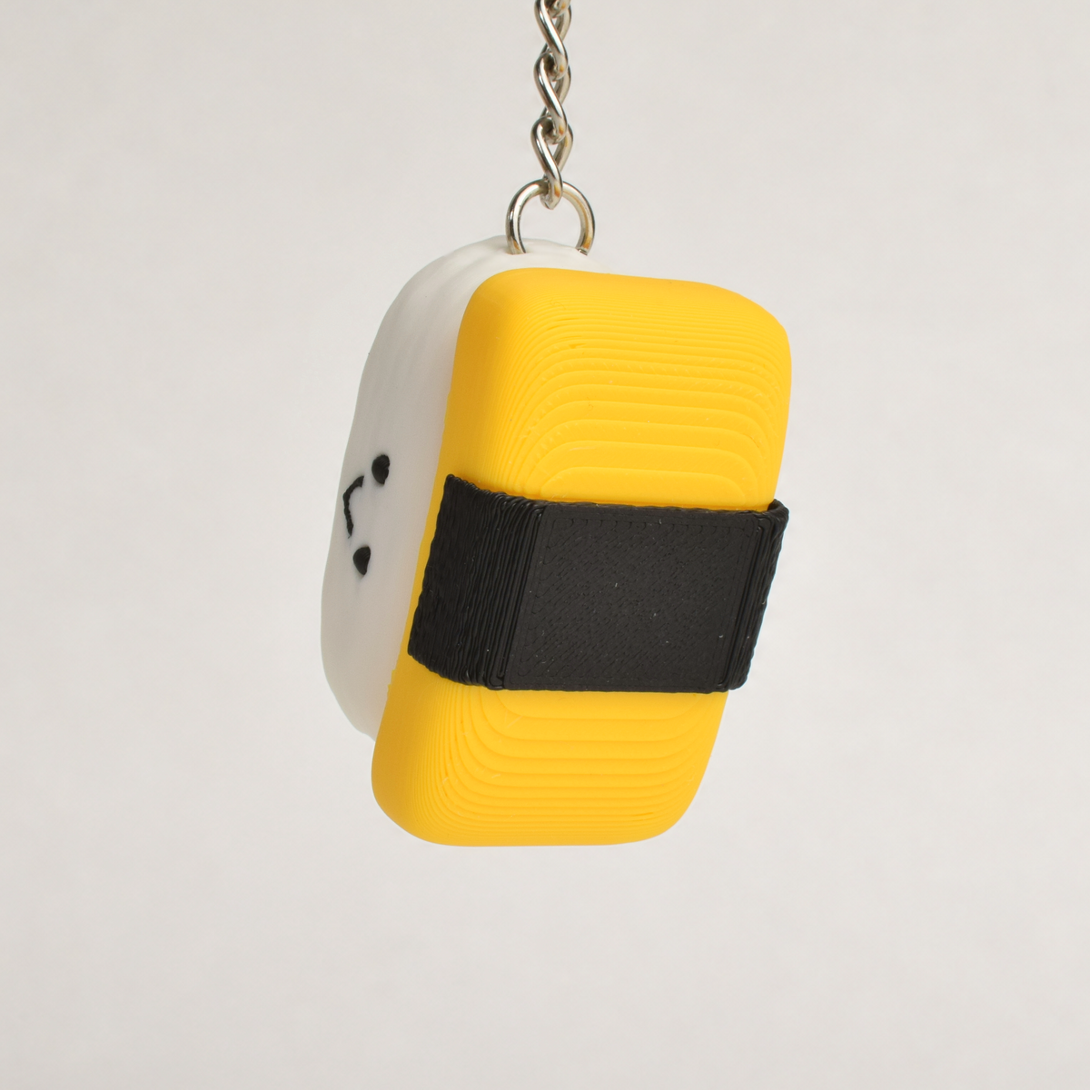 Tamago Sushi Fidget Clicker, on a keychain